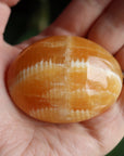 Orange calcite pocket stone 12 new