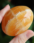 Orange calcite pocket stone 12 new