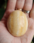 Orange calcite pocket stone 13 new