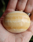 Orange calcite pocket stone 13 new