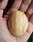 Orange calcite pocket stone 13 new