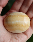 Orange calcite pocket stone 13 new