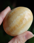 Orange calcite pocket stone 13 new