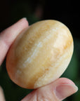 Orange calcite pocket stone 13 new