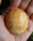 Orange calcite pocket stone 14 new