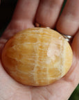 Orange calcite pocket stone 14 new