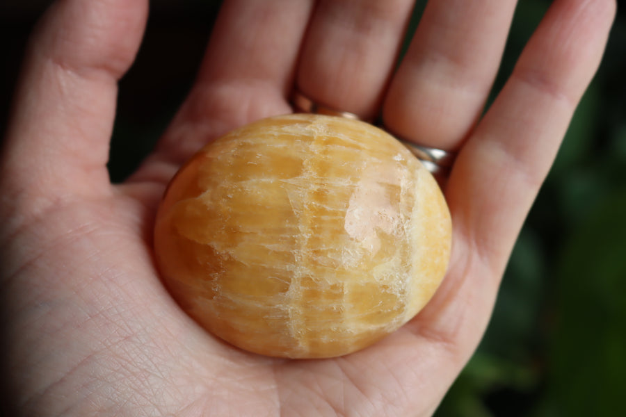 Orange calcite pocket stone 14 new