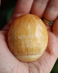 Orange calcite pocket stone 14 new