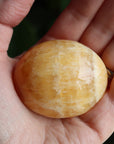 Orange calcite pocket stone 14 new