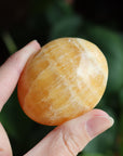 Orange calcite pocket stone 14 new