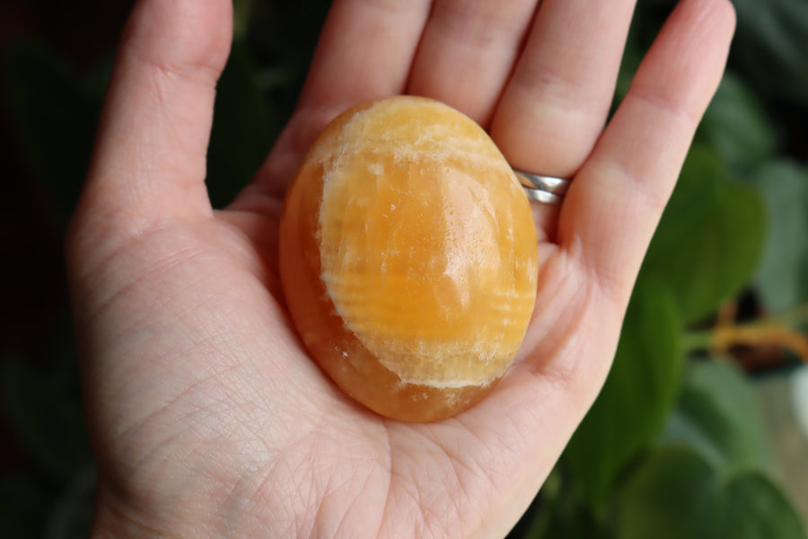 Orange calcite pocket stone 16 new