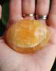 Orange calcite pocket stone 16 new