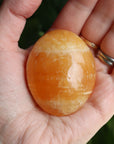 Orange calcite pocket stone 16 new