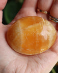 Orange calcite pocket stone 16 new