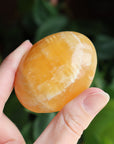 Orange calcite pocket stone 16 new