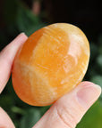 Orange calcite pocket stone 16 new