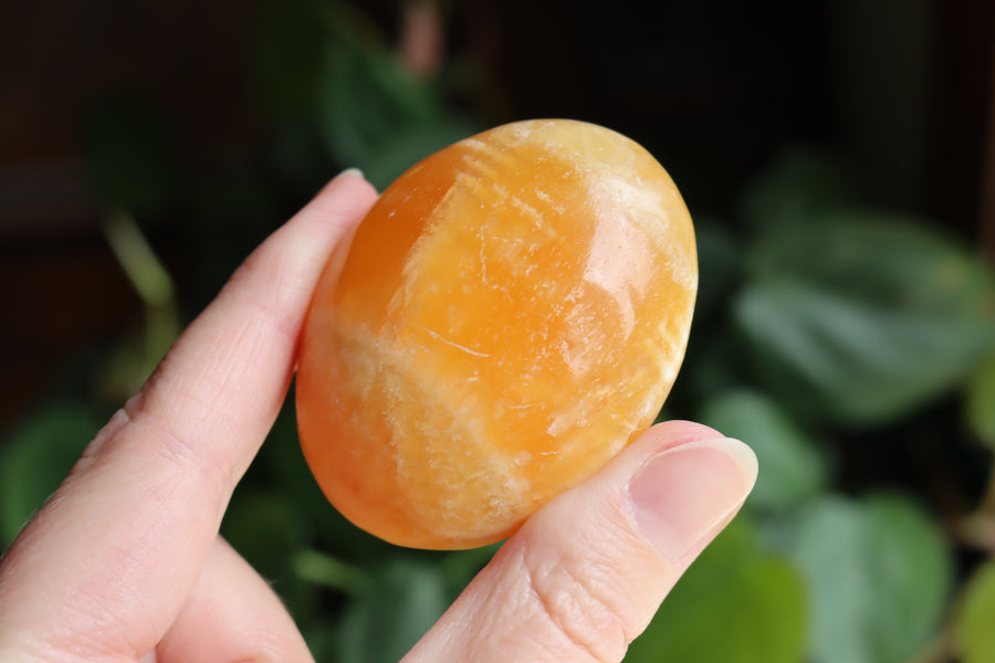 Orange calcite pocket stone 16 new