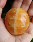 Orange calcite pocket stone 17 new