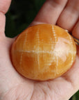 Orange calcite pocket stone 17 new