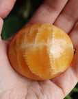 Orange calcite pocket stone 17 new