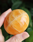 Orange calcite pocket stone 17 new