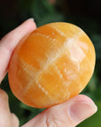 Orange calcite pocket stone 17 new